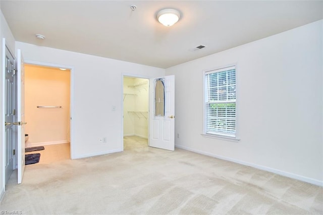 4712 Brighton Park Dr Unit 1B, Winston-Salem, NC 27103 - unfurnished bedroom with a spacious closet, carpet floors, baseboards, and a closet