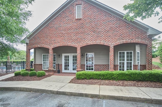 4712 Brighton Park Dr Unit 1B, Winston-Salem, NC 27103 - view of front of house featuring brick siding, french doors, and covered porch