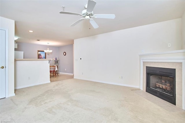 4712 Brighton Park Dr Unit 1B, Winston-Salem, NC 27103 - unfurnished living room with a chandelier, carpet floors, a tiled fireplace, baseboards, and a ceiling fan