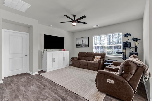 living room featuring wood-type flooring and ceiling fan