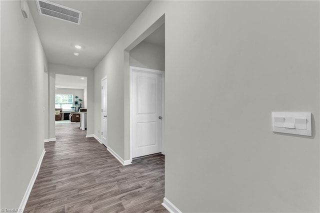 hallway with hardwood / wood-style flooring