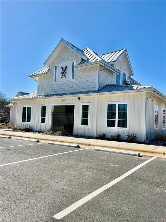 view of front of property with a standing seam roof, metal roof, and board and batten siding