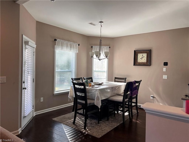dining area featuring a chandelier and dark hardwood / wood-style floors
