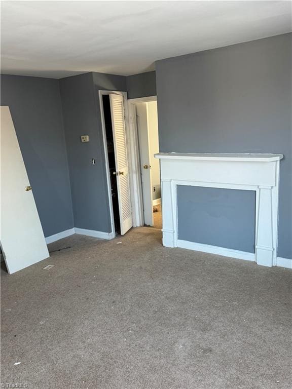 unfurnished living room with carpet flooring