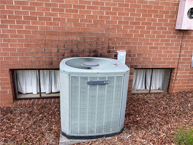 details featuring brick siding and central AC unit