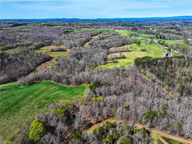 birds eye view of property with a wooded view