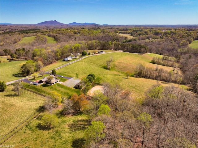 birds eye view of property with a rural view, a mountain view, and a wooded view