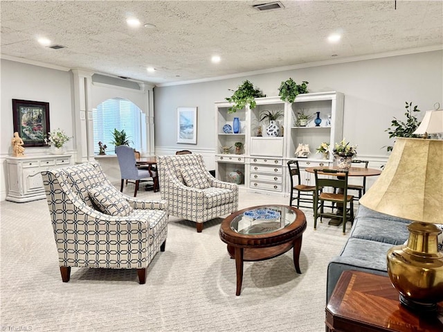 carpeted living room with a textured ceiling and ornamental molding