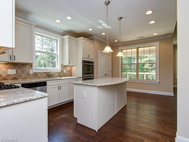 kitchen with white cabinets, hanging light fixtures, dark wood-type flooring, and a center island