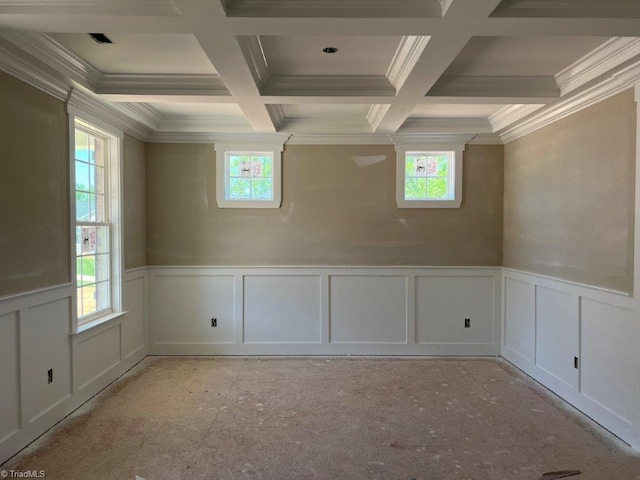 unfurnished room featuring coffered ceiling, a wealth of natural light, and beam ceiling