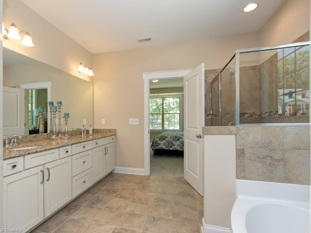 bathroom featuring vanity and independent shower and bath