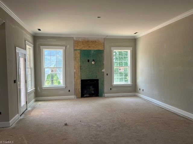 unfurnished living room featuring light colored carpet, ornamental molding, and plenty of natural light