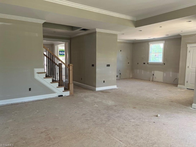 spare room with light colored carpet, a raised ceiling, and ornamental molding