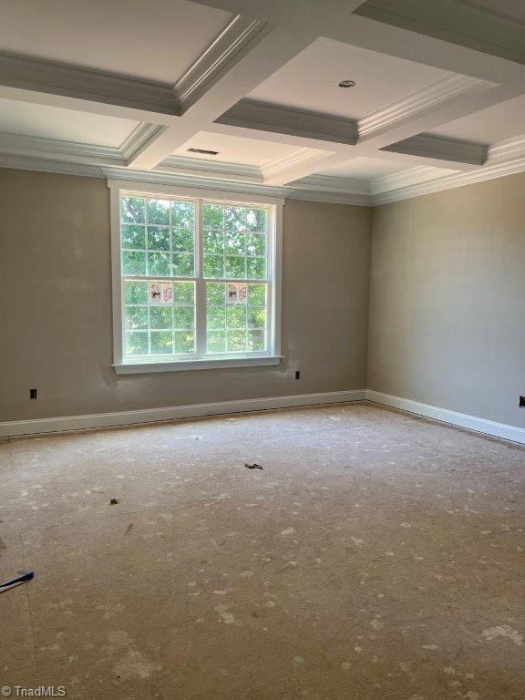 unfurnished room with beam ceiling, crown molding, and coffered ceiling