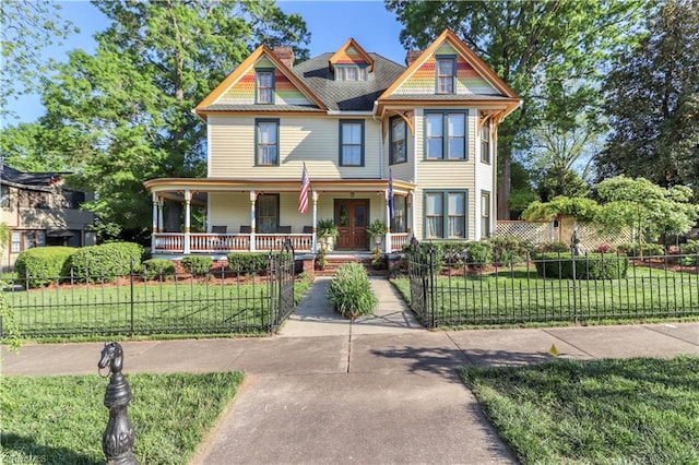 victorian home with a porch and a front yard