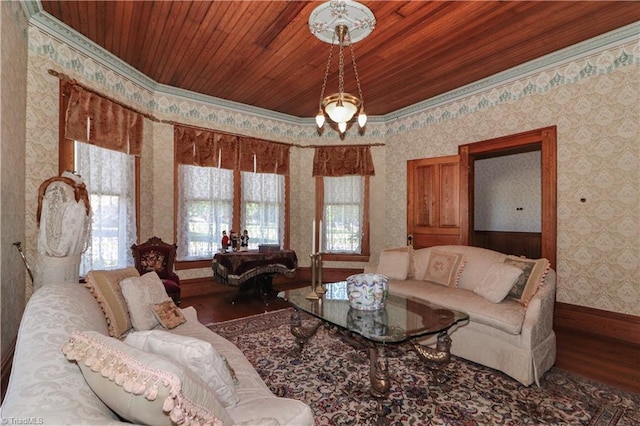 living room featuring hardwood / wood-style flooring, crown molding, and wooden ceiling