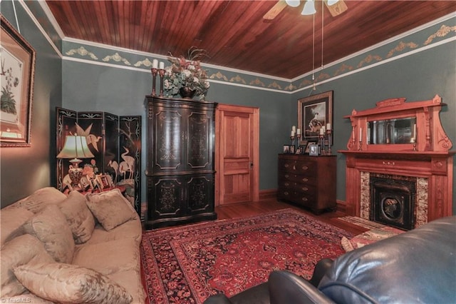 living room with wood ceiling, ceiling fan, dark hardwood / wood-style flooring, and crown molding