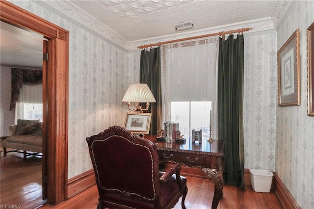 home office featuring hardwood / wood-style flooring, ornamental molding, and a textured ceiling