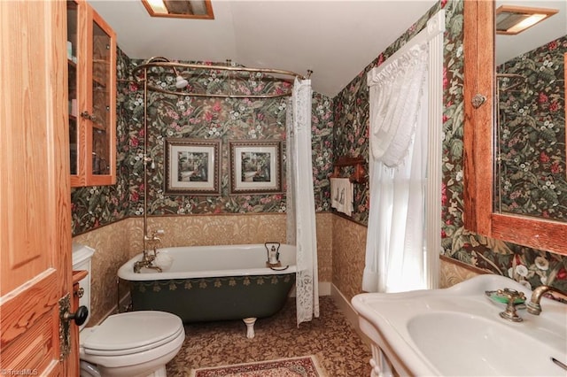 bathroom with sink, a tub, toilet, and tile floors