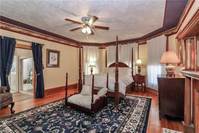 bedroom featuring ceiling fan, crown molding, and hardwood / wood-style flooring