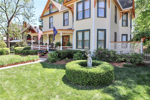 victorian-style house featuring a front lawn