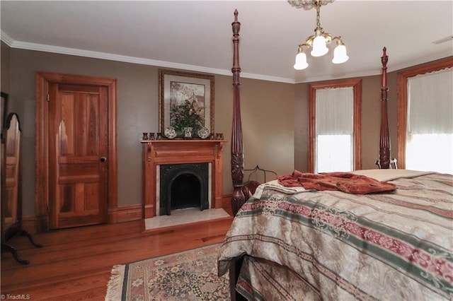 bedroom with wood-type flooring, crown molding, and multiple windows