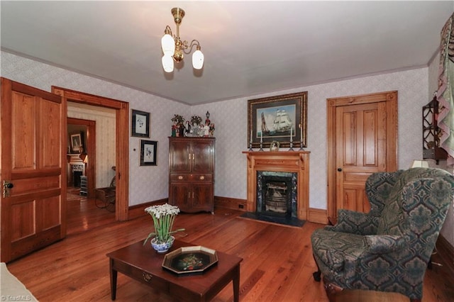 living room featuring hardwood / wood-style floors, a chandelier, and a high end fireplace