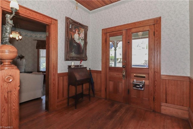 entryway featuring crown molding and dark wood-type flooring