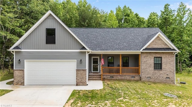 4944 Little Store Rd, Mcleansville, NC 27301 - view of front of home featuring brick siding, covered porch, concrete driveway, and crawl space