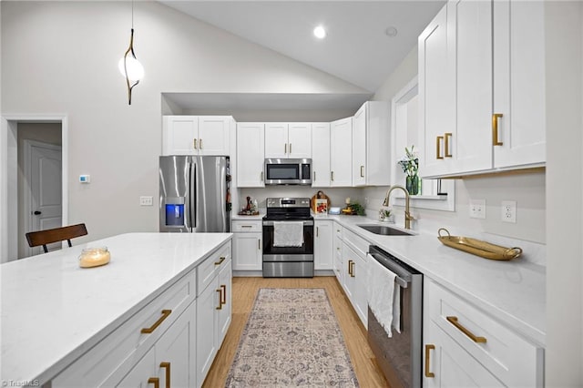4944 Little Store Rd, Mcleansville, NC 27301 - kitchen with stainless steel appliances, a sink, light wood-type flooring, white cabinetry, and high vaulted ceiling