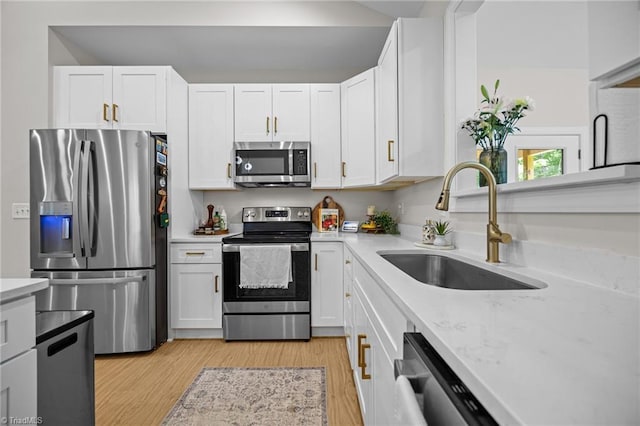 4944 Little Store Rd, Mcleansville, NC 27301 - kitchen with appliances with stainless steel finishes, a sink, and white cabinets