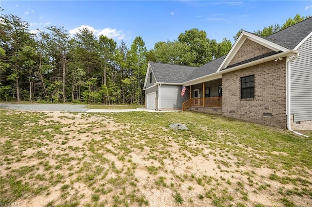 4944 Little Store Rd, Mcleansville, NC 27301 - view of home's exterior with crawl space, a porch, driveway, brick siding, and a lawn