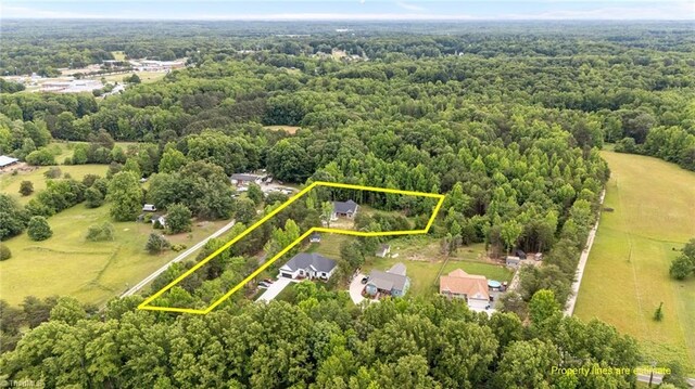 4944 Little Store Rd, Mcleansville, NC 27301 - aerial view of property and surrounding area with property parcel outlined and a heavily wooded area