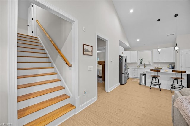 4944 Little Store Rd, Mcleansville, NC 27301 - living area featuring light wood-style floors, recessed lighting, stairs, baseboards, and high vaulted ceiling