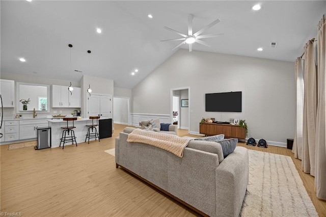 4944 Little Store Rd, Mcleansville, NC 27301 - living area featuring ceiling fan, a wainscoted wall, light wood-type flooring, recessed lighting, and high vaulted ceiling