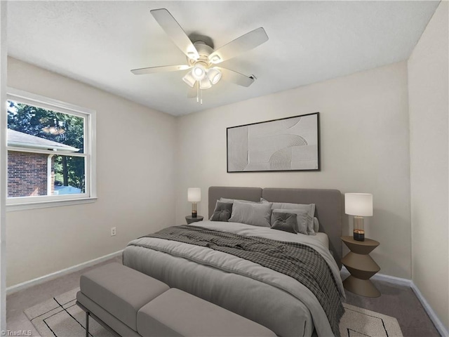 carpeted bedroom with a ceiling fan and baseboards