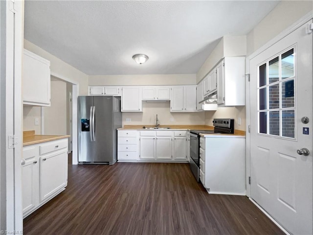 kitchen featuring under cabinet range hood, a sink, white cabinetry, appliances with stainless steel finishes, and dark wood finished floors