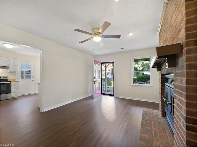 unfurnished living room featuring a fireplace, baseboards, and dark wood-style flooring