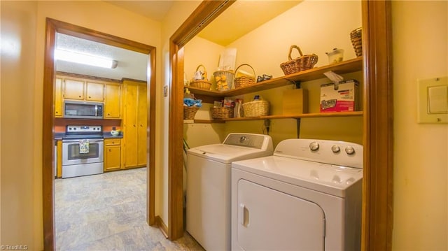 laundry room featuring washing machine and clothes dryer