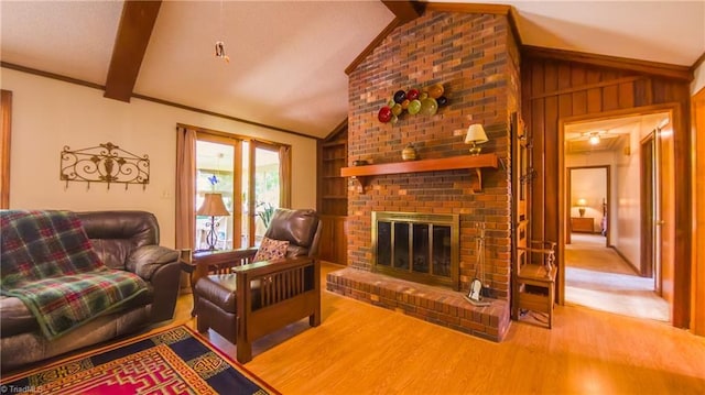 living room featuring wood finished floors, a fireplace, and wood walls