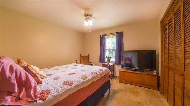 carpeted bedroom featuring a closet and a ceiling fan