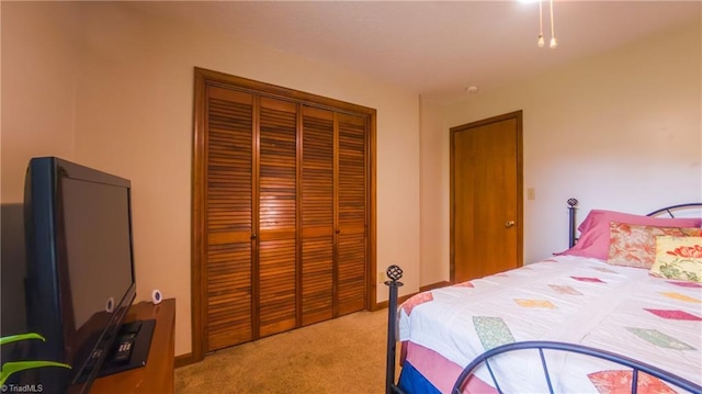 bedroom featuring light colored carpet and a closet