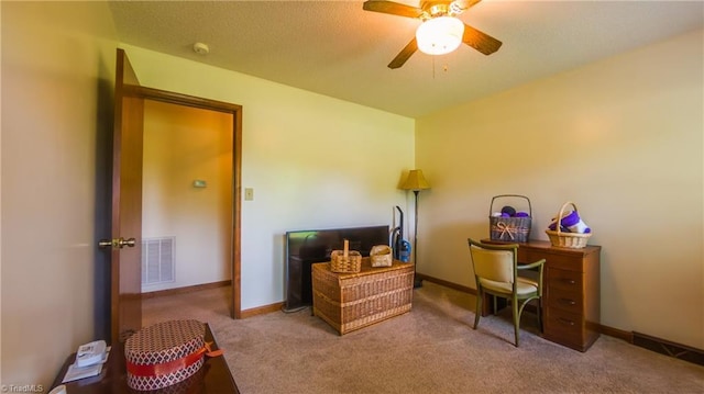 carpeted office with ceiling fan and baseboards