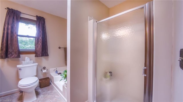 bathroom with a shower stall, toilet, a garden tub, and baseboards