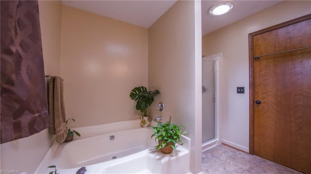 full bath with a stall shower and a bath