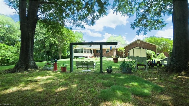 view of green lawn with a storage shed and an outdoor structure