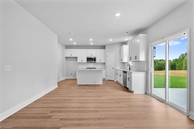 4192 Emmas Way E, Bend, NC 27018 - kitchen featuring appliances with stainless steel finishes, white cabinetry, recessed lighting, and baseboards