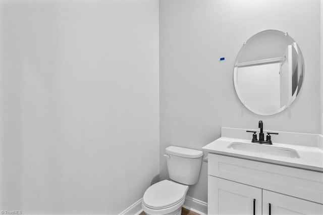4192 Emmas Way E, Bend, NC 27018 - bathroom featuring toilet, vanity, and baseboards