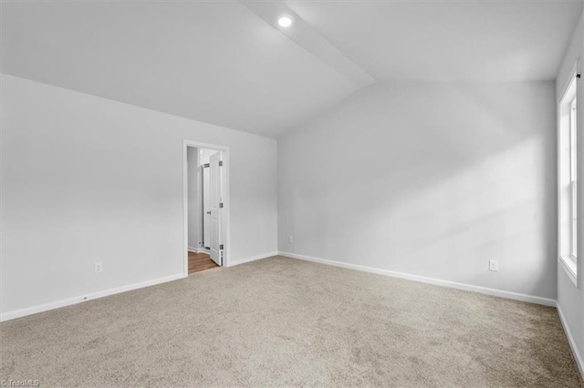 4192 Emmas Way E, Bend, NC 27018 - spare room with carpet flooring, vaulted ceiling, and baseboards
