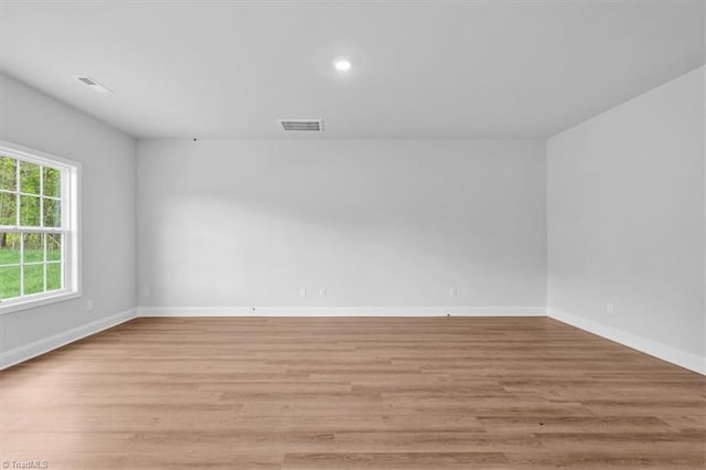 4192 Emmas Way E, Bend, NC 27018 - empty room featuring light wood-type flooring, baseboards, and recessed lighting